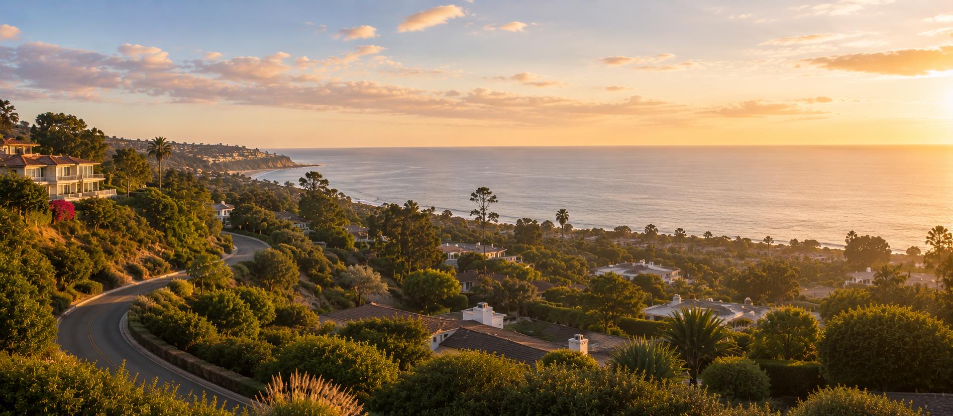 Pacific Palisades at golden hour — a coastal bluff with a winding canyon road, mature greenery, and the ocean horizon